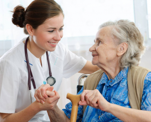 Elderly patient speaking to a nurse