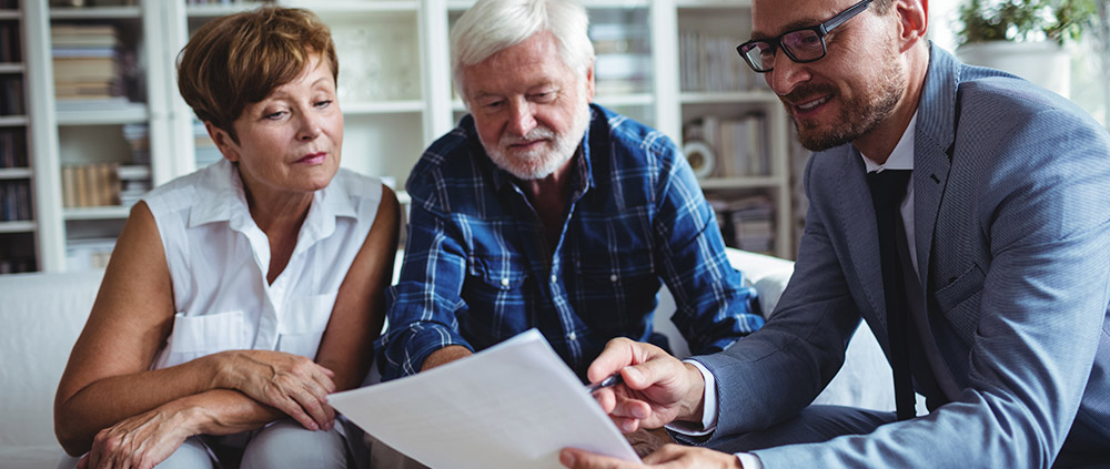 Advisor speaking to elderly couple