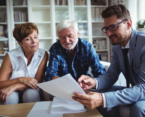 Advisor speaking to elderly couple